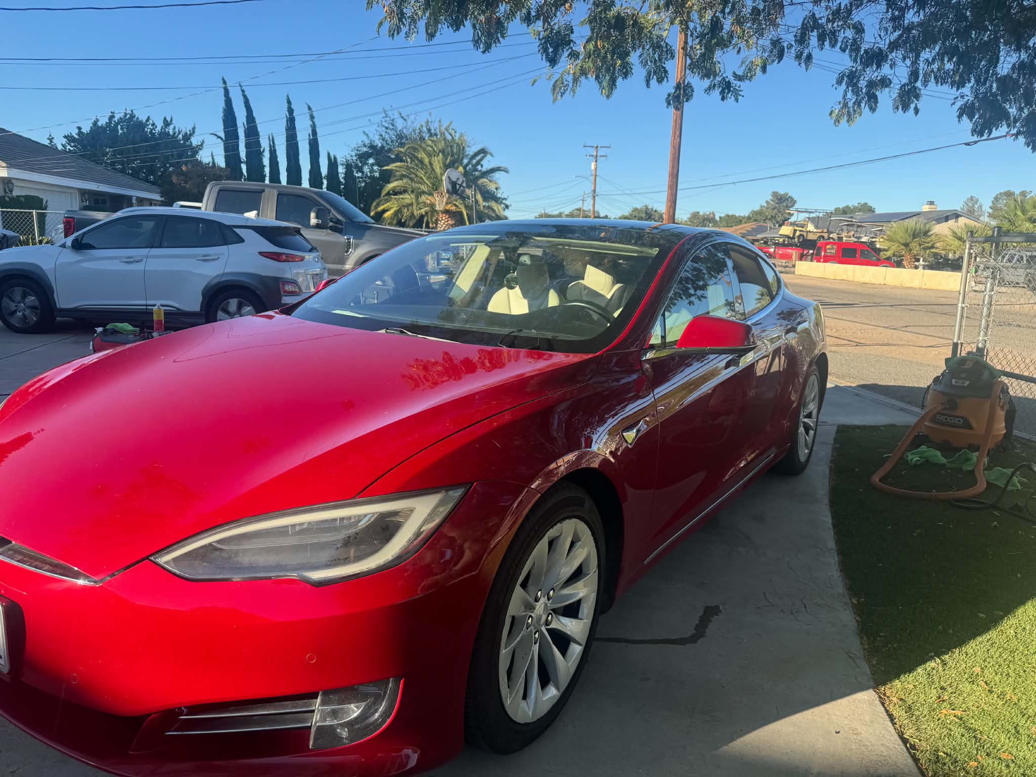 Red Tesla Model S gleaming after an exterior detail