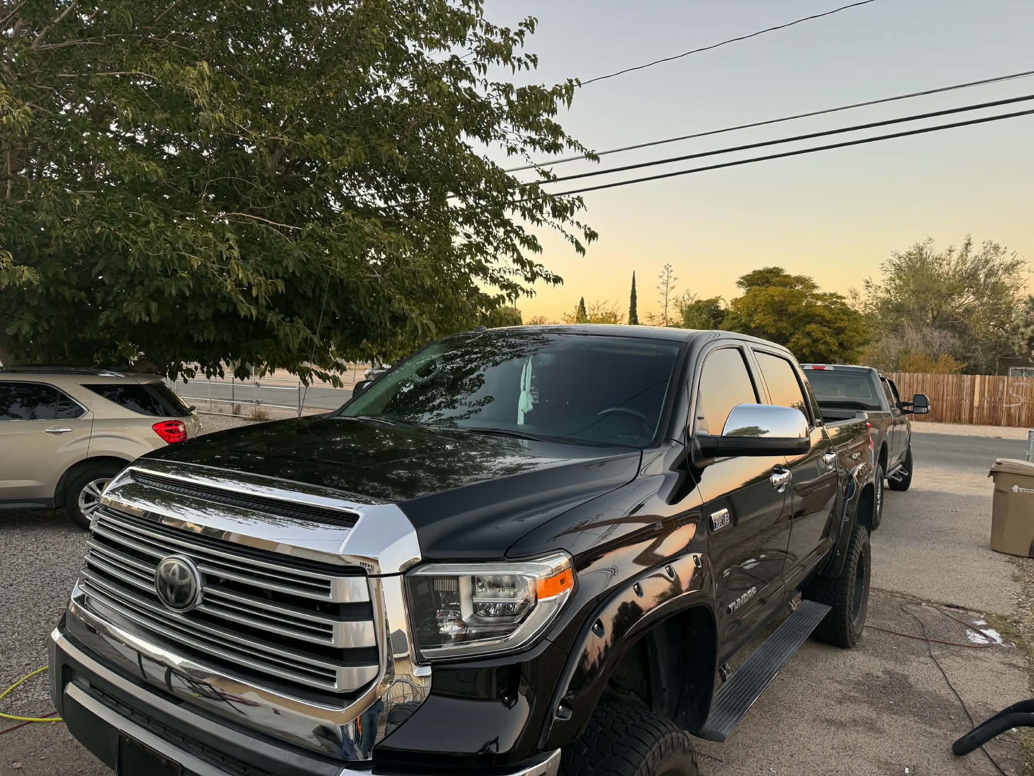 Black Toyota Tundra gleaming at sunset after an exterior wash, clay and seal